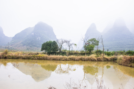 Mountains and countryside scenery in the mistの写真素材