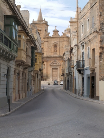 Hal Tarxien Parish Church dominates this view of traditional Maltese balconies in Triq Il Kbiraの写真素材