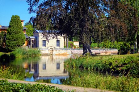 A baroque villa reflecting on a still pondの写真素材