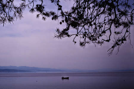 Blue evening in sea with a boatの写真素材