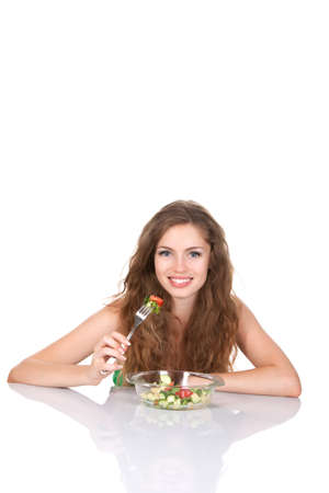 Portrait of attractive young smile woman eating vegetable saladの写真素材