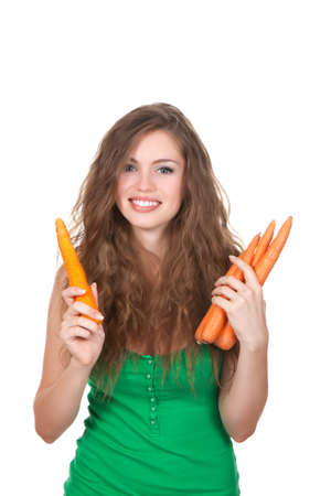 young woman hold orange fresh raw carrot in handの写真素材