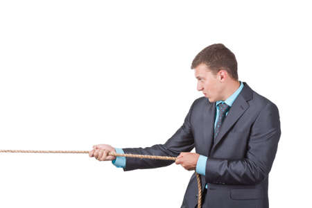 Businessman pulling a rope isolated on whiteの写真素材