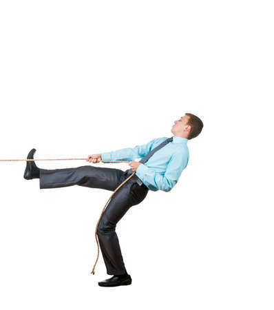 Businessman pulling a rope isolated on whiteの写真素材