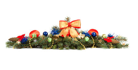 Christmas decoration laying in pine branches isolated over whiteの写真素材