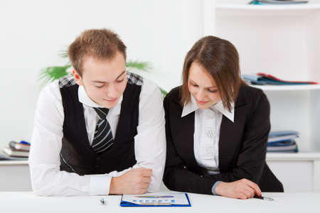 young business people in office at the deskの写真素材