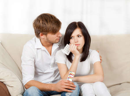 beautiful young couple sitting on a sofaの写真素材