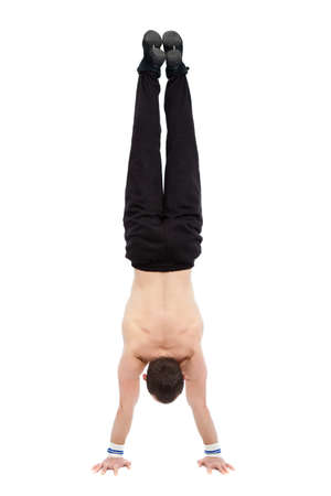 caucasian man acrobatics gymnastic doing a exercise athletic sportsmanの写真素材