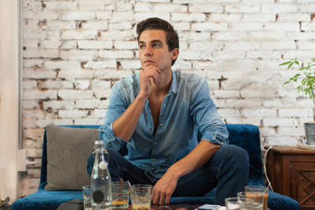 Sad Man Sitting at Cafe Think Hold Chin Looking to Windowの写真素材