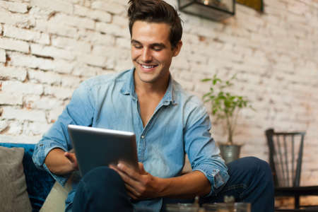 Casual Man Using Tablet Computer Smileの写真素材
