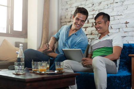 Two Men Using Tablet Computer at Cafe, Friends Guys Sitting Coffee Shop