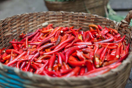 basket of red chilly pepper asian street marketの写真素材