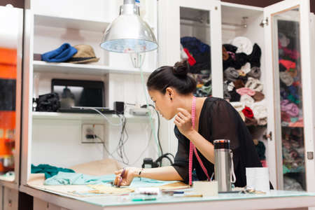 Asian woman tailor fashion clothes dress designer working with fabric