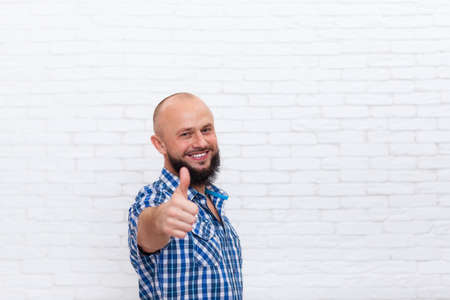 Casual Bearded Man Thumb Up Hand Gesture Smiling Over White Brick Wall