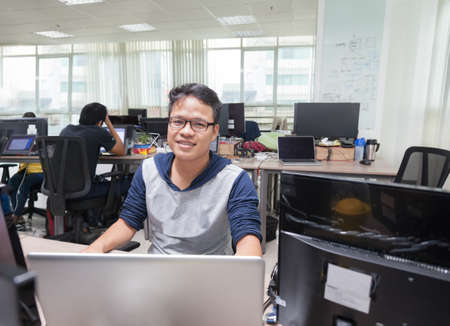 Asian Man Software Developer Working Real Office