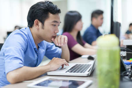Asian Businessman Sitting At Desk Working Laptop Computer Business People Real Office