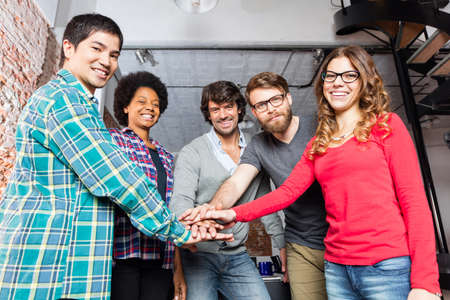 Diverse people team hands on top of each other support teamwork mix race group smile office