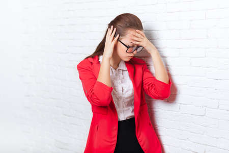 Businesswoman hold hands on head, ache, pain depressed wear red jacket glasses stressed business...