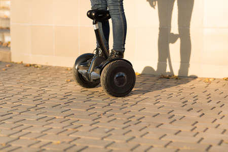 Male legs on electrical scooter outdoors gyro scooter personal transportの写真素材