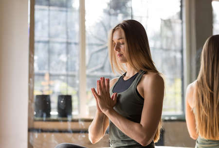 Woman Doing Yoga Exercises In Gym, Sport Fitness Girl Sitting Lotus Pose Meditation Relaxationの写真素材