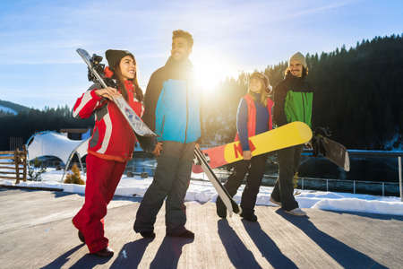 People Group With Snowboard And Ski Resort Snow Winter MountainCheerful Friends Extreme Sport Vacationの写真素材