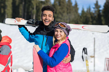 Coupe Ski And Snowboard Resort Winter Snow Mountain Hispanic Man And Woman Embrace Holiday Extreme Sport Vacationの写真素材