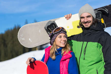 Couple With Snowboard Ski Resort Snow Winter Mountain Smiling Man And Woman Extreme Sport Vacation Holidayの写真素材