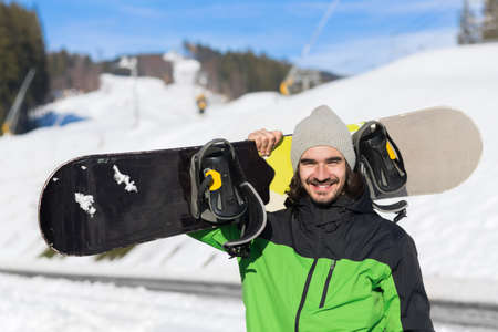 Man Tourist Snowboard Ski Resort Snow Winter Mountain Happy Smiling Guy On Holiday Extreme Sport Vacationの写真素材