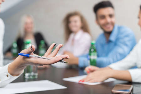 Business People Group Sit At Office Desk Meeting, Young Smiling Businesspeople Team Conference Discussion Project Mix Race People Cooperationの写真素材