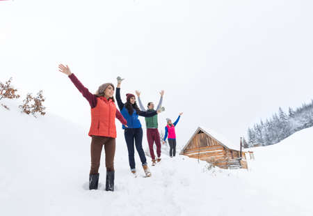 Friends On Mountain Top Winter Snow Forest, Young People Group Cheerful Raised Hands Wood Nature Landscapeの写真素材