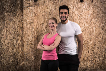 Sport Fitness Couple, Young Healthy Man And Woman Gym Interior Doing Exercises, People Full Length Portraitの写真素材
