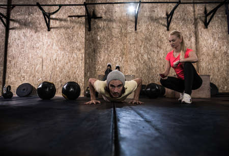 Sport Fitness People Crossfit Training, Young Healthy Man Do Push Ups Woman Trainer Gym Interior