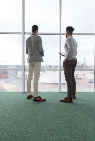 Two Business Man Using Tablet Computer Coworking Center Business Team Coworkers Stand in front Big...