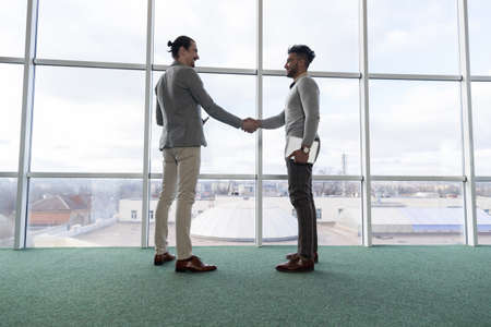 Two Business Man Shake Hand Agreement Coworking Center Business Team Coworkers Stand in front Big...