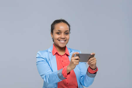 Young Business Woman Using Cell Smart Phone African American Girl Happy Smile Businesswoman Isolated Over Gray Backgroundの写真素材