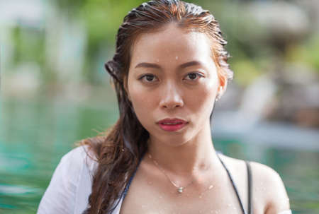 Beautiful Woman Swimming Pool At Resort Relaxed Portrait Young Asian Girl Tropical Vacationの写真素材