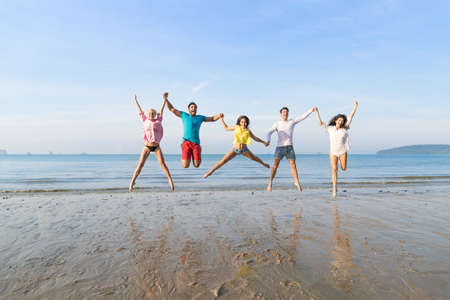 Young People Group Jump On Beach Summer Vacation, Happy Smiling Friends Sea Ocean Holiday Travelの写真素材
