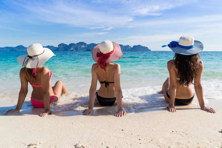 Girl Group On Beach Summer Vacation, Young Woman Back Rear View Sit On Sand Sea Ocean Holiday Travelの写真素材