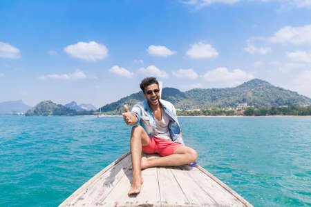 Young Man Tourist Sail Long Tail Thailand Boat Ocean Sea Vacation Travel Trip Beautiful Natureの写真素材