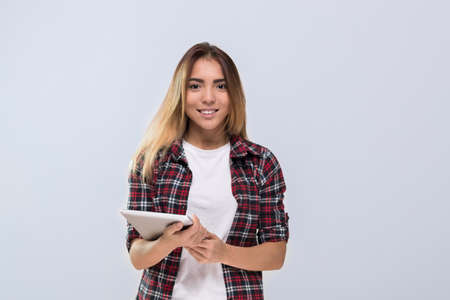 Casual Woman Happy Smile Young Asain Girl Hold Tablet Computer Wear Checked Shirt Isolated Over Grey Backgroundの写真素材