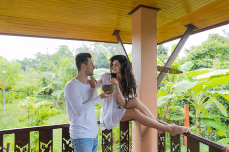 Couple Using Cell Smart Phone On Summer Terrace, Young Man And Woman Happy Smiling Hold Mobile...