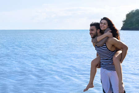 Couple Beach Summer Vacation, Man Carry Woman Beautiful Young Happy Man And Woman Smile Sea Ocean Holiday Travelの写真素材