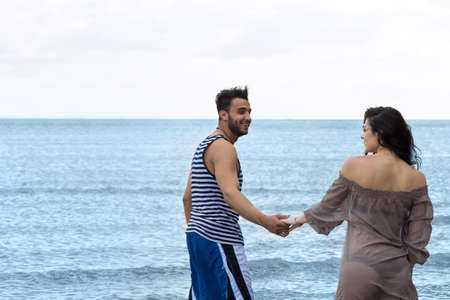 Couple Walking Beach Summer Vacation, People Beautiful Young Happy Man And Woman Smile Sea Ocean Holiday Travelの写真素材