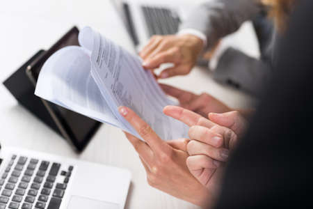 Business Women Work With Documents In Creative Modern Office, Two Businesswoman Teamwork Female Discussing Paper Or File Report Planning Project Together Sitting At Deskの写真素材