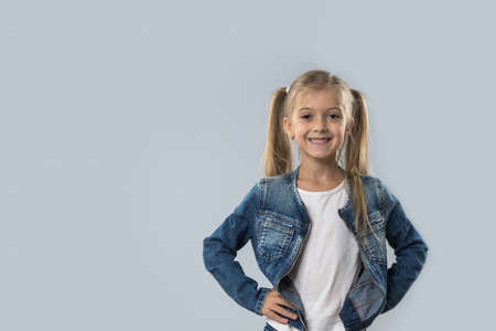 Beautiful Little Girl Happy Smiling Wear Jeans Coat Isolated Over Gray Backgroundの写真素材