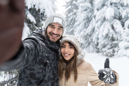 Man Taking Selfie Photo Young Romantic Couple Smile Snow Forest Outdoor Winter Pine Woods