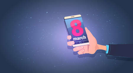 Male Hand Holding Smart Phone With 8 March MEssage Happy International Women Day Holiday Concept...