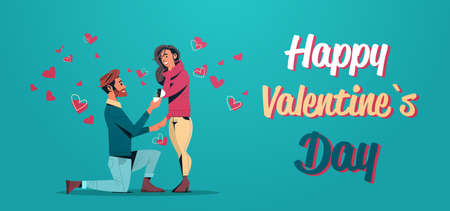 man kneeling holding engagement ring proposing to woman marry him happy valentines day concept young...