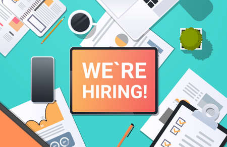 we are hiring recruitment concept top angle view desktop laptop smartphone paper document financial...