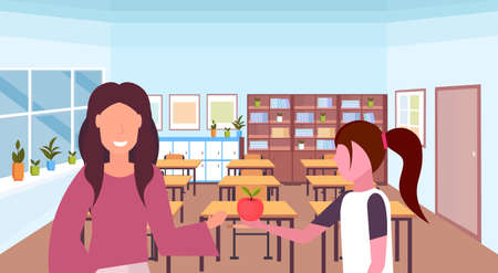 schoolgirl giving apple to woman teacher education concept modern school classroom interior female characters portrait horizontal flat vector illustrationのイラスト素材